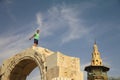 The boy is playing on the walls of Damascus.