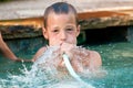 Boy playing with water hose in pool Royalty Free Stock Photo