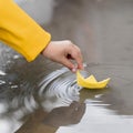 boy playing water with paper boat close up. High quality photo Royalty Free Stock Photo