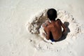 Boy playing in the white sand