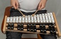 Boy playing the xylophone, mallets in human hands