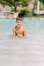 A boy plays with a ball in the water Royalty Free Stock Photo