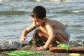 BOY PLAYS ON BEACH Royalty Free Stock Photo