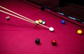 Boy plays billiard or pool in club. Young Kid learns to play snooker. Boy with billiard cue strikes the ball on table. Royalty Free Stock Photo