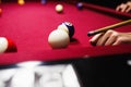 Boy plays billiard or pool in club. Young Kid learns to play snooker. Boy with billiard cue strikes the ball on table. Royalty Free Stock Photo