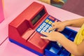 The boy plays with the children`s cash register Royalty Free Stock Photo