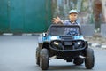 The boy plays, drives a car in the park. A cute little boy Royalty Free Stock Photo