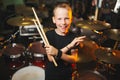 Boy plays drums in recording studio