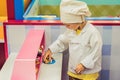 The boy plays the game as if he were a cook or a baker in a chil Royalty Free Stock Photo