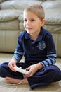 Boy plays handheld video game Royalty Free Stock Photo