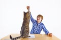 Boy plays with his tabby cat Royalty Free Stock Photo