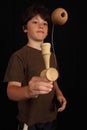 Boy plays with Kendama toy