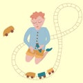 The boy plays the railroad. Children`s games, pastime, classes, entertainment, toys.