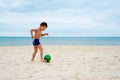 Boy plays soccer on beach Royalty Free Stock Photo