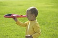 A boy plays in a toy red plane Royalty Free Stock Photo