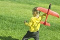 A boy plays in a toy red plane Royalty Free Stock Photo