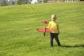 A boy plays in a toy red plane Royalty Free Stock Photo
