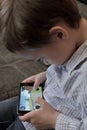 Boy playing a video game on mobile phone Royalty Free Stock Photo