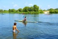 Boy plays in water and boat Royalty Free Stock Photo