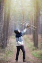 A boy plays in the woods with a toy plane. autumn games in the w Royalty Free Stock Photo