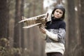 A boy plays in the woods with a toy plane. autumn games in the w Royalty Free Stock Photo