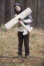 A boy plays in the woods with a toy plane. autumn games in the w Royalty Free Stock Photo