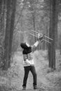 A boy plays in the woods with a toy plane. autumn games in the w Royalty Free Stock Photo