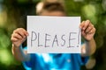 Boy with Please sign Royalty Free Stock Photo