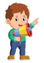 The boy is pointing on something and using a loudspeaker Royalty Free Stock Photo