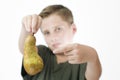 Boy points to a pear Royalty Free Stock Photo