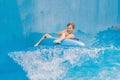 Boy on a pool float on artificial waves in a water park Royalty Free Stock Photo