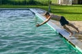 The boy in the pool jumps into the cold water Royalty Free Stock Photo