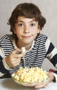 Boy with pop corn plate close up smile photo
