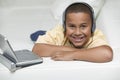 Boy With Portable DVD Player And Headphones Royalty Free Stock Photo