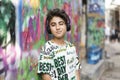 Boy portrait with earphones and grafiti behind Royalty Free Stock Photo