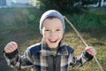 Boy portrait outdoor smiling grasping. happy smiling child outdoor playing warrior with stick