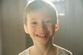 Boy portrait in sun light with transparent ears. happy smiling kid at sunset in sunny rays