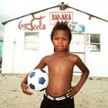 Boy posing with a ball in township, South Africa. Royalty Free Stock Photo