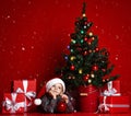 Boy posing in red hat near the Christmas tree Royalty Free Stock Photo