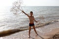 Boy posing with tumbleweed plant on beach of Azov sea Royalty Free Stock Photo