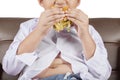 Boy with potbelly enjoy a cheeseburger