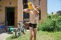 Boy pouring water on himself. Summer refreshing procedure. Warm weather background. Healthy lifestyle. Happy childhood. Royalty Free Stock Photo