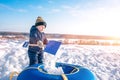 The boy pours snow child`s shovel. In the winter on the street in the city of the weekend. Rest with a child in nature Royalty Free Stock Photo