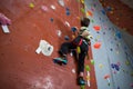 Boy practicing rock climbing in fitness studio Royalty Free Stock Photo