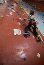 Boy practicing rock climbing in fitness studio Royalty Free Stock Photo