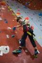 Boy practicing rock climbing in fitness studio Royalty Free Stock Photo