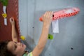 Boy practicing rock climbing in fitness studio Royalty Free Stock Photo