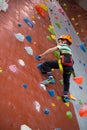 Boy practicing rock climbing in fitness studio Royalty Free Stock Photo