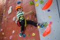 Boy practicing rock climbing in fitness studio Royalty Free Stock Photo