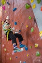 Boy practicing rock climbing in fitness studio Royalty Free Stock Photo